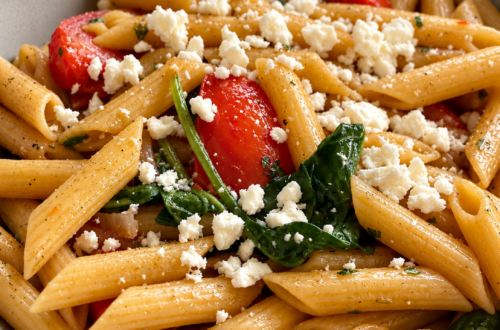 Copycat Noodles and Company Pasta Fresca with penne pasta, tomatoes, spinach, red onion, garlic, and feta cheese in a bowl.