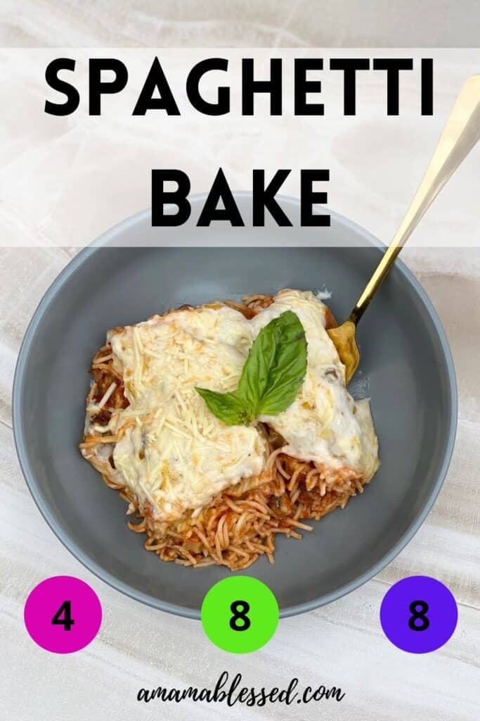 Spaghetti bake sits in a grey bowl on top of a counter with a golden fork