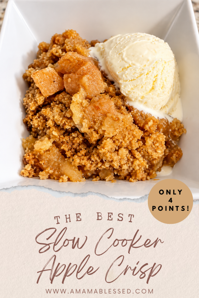 Fresh skinny slow cooker apple crisp sits in a white bowl with vanilla ice cream. 