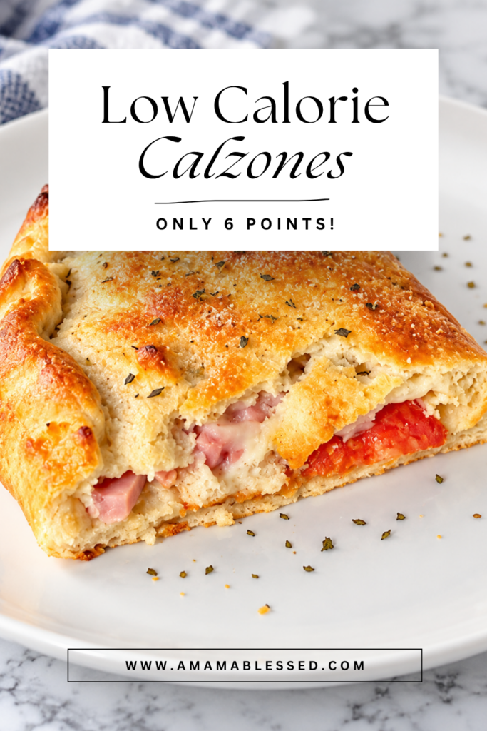 A freshly baked calzone sits on top of a white plate. 