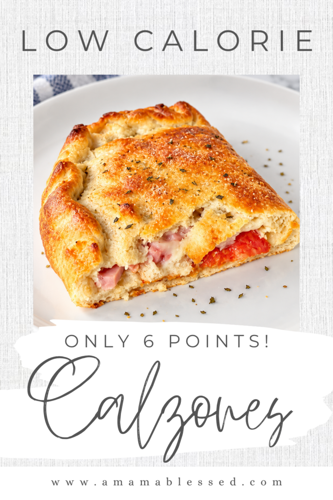 A freshly baked low calorie calzone topped with seasoning sits on top of a white plate. 