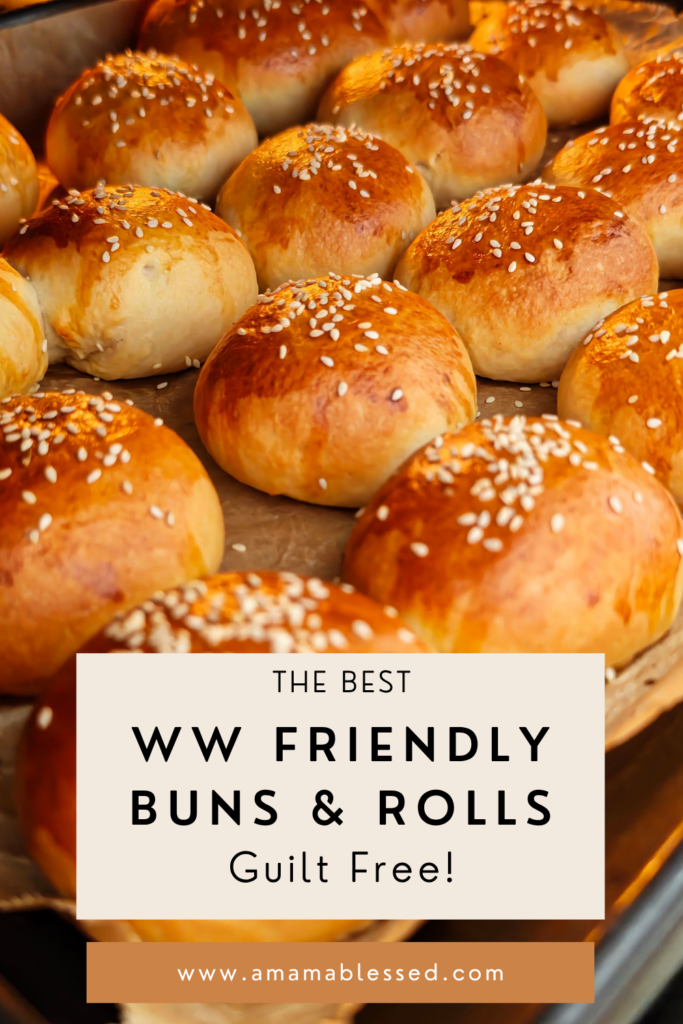 A tray of freshly baked rolls topped with sesame seeds.