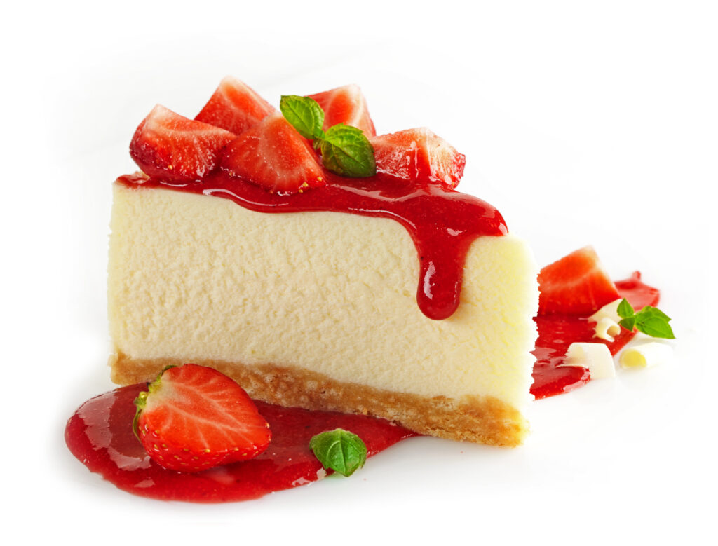 A slice of cheesecake topped with strawberries